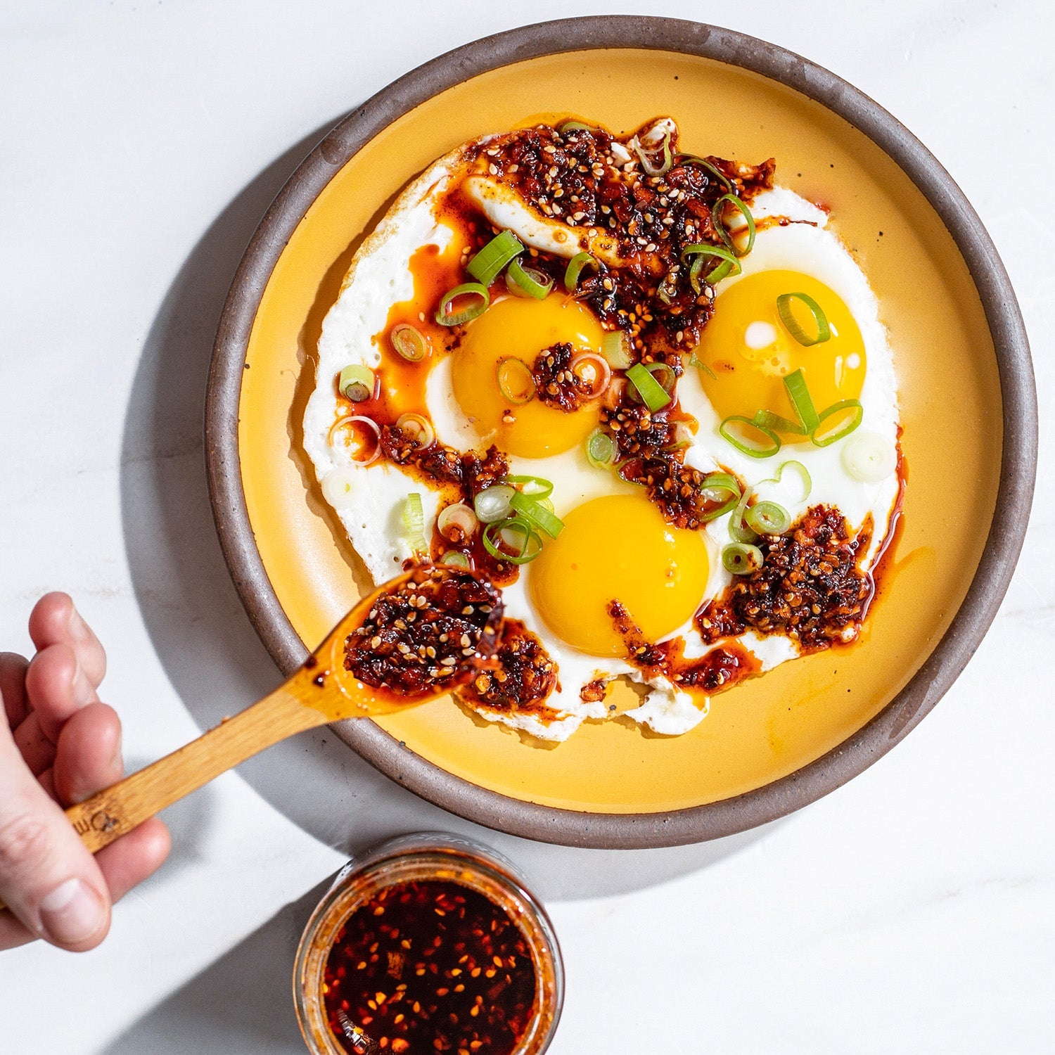 Plate of fried eggs with Chili Crunch spooned over