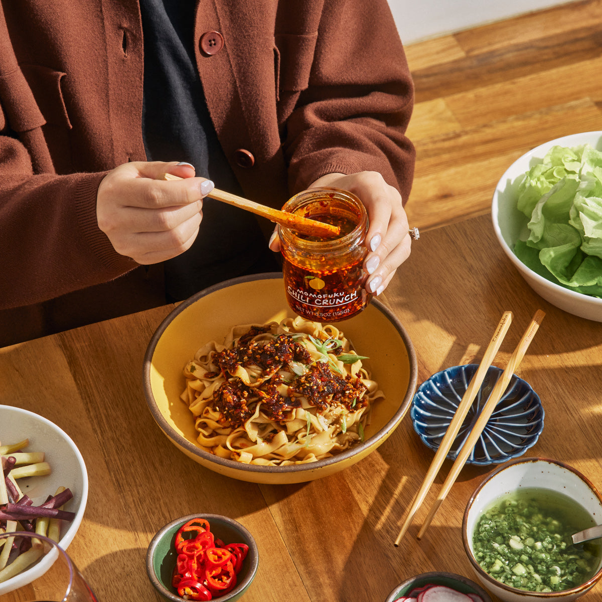 Chili Crunch spooned over a bowl of noodles