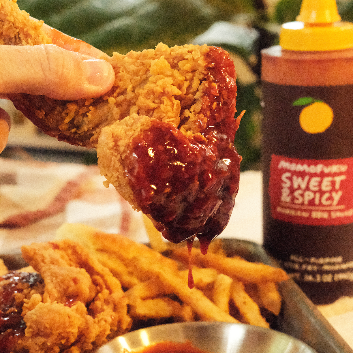 Image of fried chicken dipped in Sweet & Spicy Korean BBQ Sauce