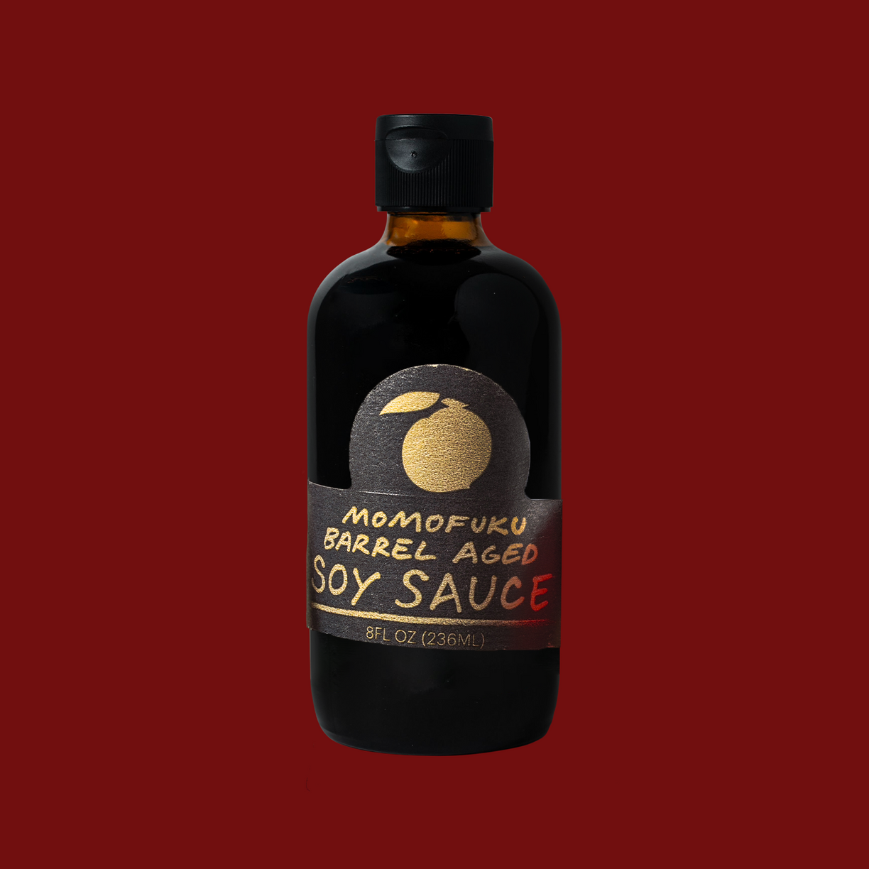 Bottle of Momofuku Barrel Aged Soy Sauce on a red background