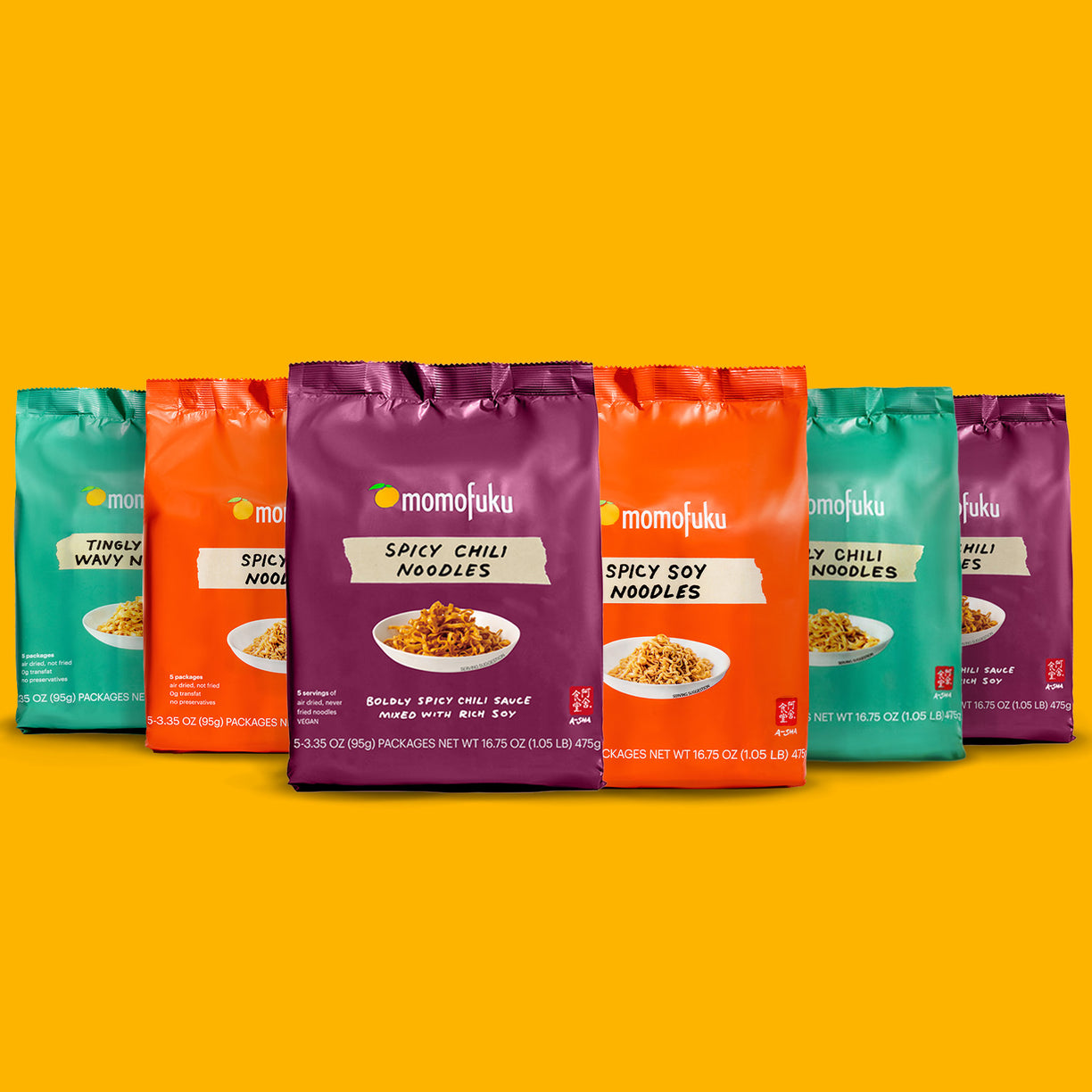 Assorted packages of Momofuku noodles in vibrant colors against a yellow background.