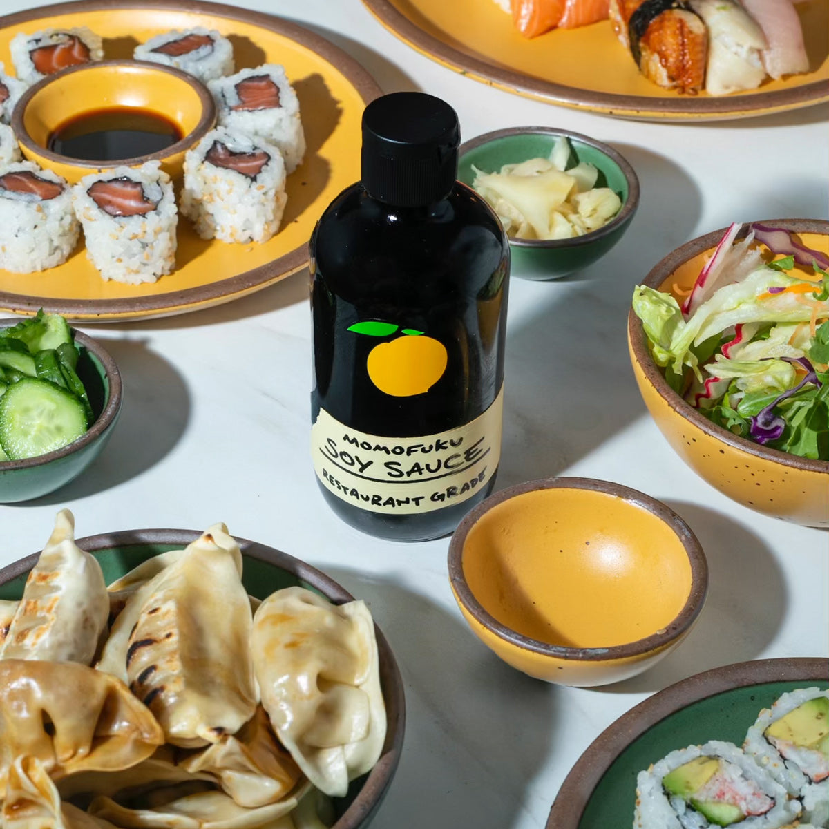 soy sauce with dumplings, salad, sushi