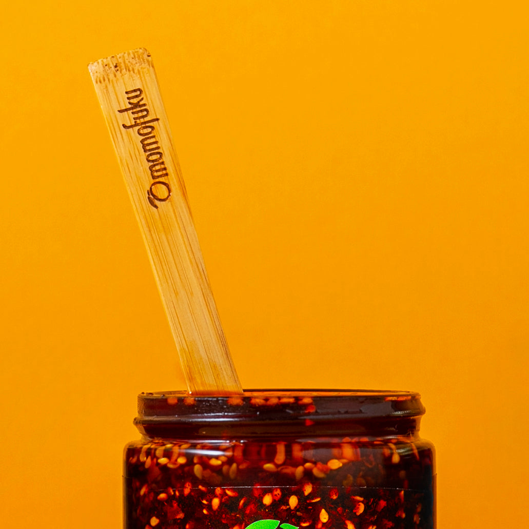 chili crunch spoon inside of a chili crunch jar