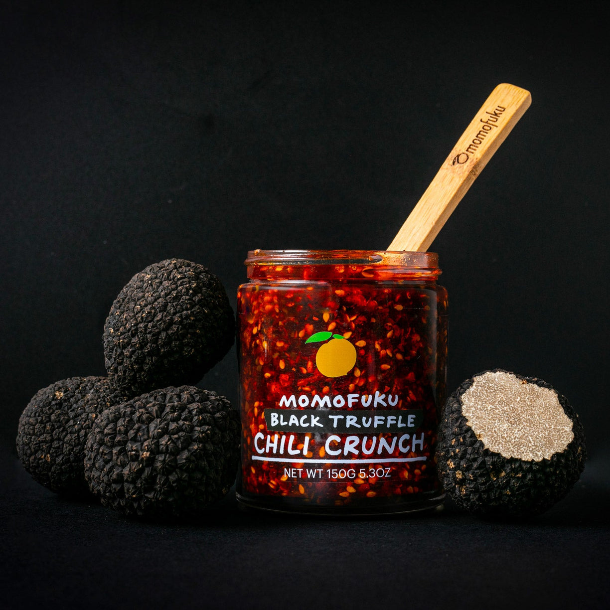 jar of black chili crunch with whole black truffles